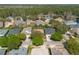 An aerial view of a neighborhood, showcasing the well-maintained homes and lush surrounding greenery at 215 Coleton Ln, Deland, FL 32724