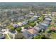 Aerial view showcasing a suburban community with tree lined streets and mature landscaping near a lake at 215 Coleton Ln, Deland, FL 32724