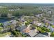 An aerial view highlighting a residential area, showcasing homes near a serene lake and abundant trees at 215 Coleton Ln, Deland, FL 32724