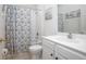 Clean, well-lit bathroom with shower-tub combo and white sink at 215 Coleton Ln, Deland, FL 32724