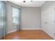 Bedroom with light walls, hardwood floors, closet, and a large window at 215 Coleton Ln, Deland, FL 32724
