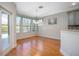 Bright dining area features hardwood floors, large windows, and stylish lighting at 215 Coleton Ln, Deland, FL 32724