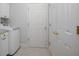 Hallway featuring a washing machine on the left and a white door directly ahead at 215 Coleton Ln, Deland, FL 32724