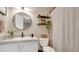 Charming bathroom with a stylish vanity, a round mirror and decorative shelves for a touch of elegance at 221 Aston Grande Dr, Daytona Beach, FL 32124