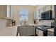 Contemporary kitchen with white cabinets, stainless steel appliances, and modern finishes at 221 Aston Grande Dr, Daytona Beach, FL 32124