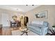 Inviting living room features a stylish dining table and a comfortable light-blue couch, perfect for relaxation at 221 Aston Grande Dr, Daytona Beach, FL 32124