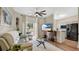 Bright living room with modern fan, plush sofa, view of the lanai and open to the kitchen at 221 Aston Grande Dr, Daytona Beach, FL 32124