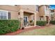 Inviting covered patio with a grill, surrounded by lush landscaping and a well-maintained lawn, ideal for relaxation at 221 Aston Grande Dr, Daytona Beach, FL 32124