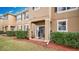 Charming covered patio with a grill, lush landscaping, and a well-manicured lawn, perfect for outdoor entertaining at 221 Aston Grande Dr, Daytona Beach, FL 32124
