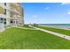 Beautiful grassy backyard with a paved path, and beach access at 2403 S Atlantic Ave # 209, Daytona Beach Shores, FL 32118