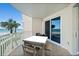 Inviting outdoor balcony with a table set and chairs, perfect for enjoying the ocean views at 2403 S Atlantic Ave # 209, Daytona Beach Shores, FL 32118