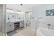 Bright bathroom with double sinks, vanity area, and separate shower and tub for a spa-like experience at 2403 S Atlantic Ave # 209, Daytona Beach Shores, FL 32118