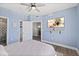 Brightly-lit bedroom with a ceiling fan and en-suite bathroom and closet at 2403 S Atlantic Ave # 209, Daytona Beach Shores, FL 32118