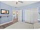 Comfortable bedroom with a ceiling fan, large closet, and an en-suite bathroom at 2403 S Atlantic Ave # 209, Daytona Beach Shores, FL 32118