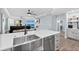 Modern kitchen featuring stainless steel appliances, a large sink, and sleek white cabinetry and ocean views at 2403 S Atlantic Ave # 209, Daytona Beach Shores, FL 32118