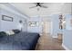 Cozy main bedroom with blue walls, tasteful decorations, and easy access to the ensuite bathroom at 2403 S Atlantic Ave # 209, Daytona Beach Shores, FL 32118