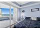 Light-filled main bedroom with balcony access offers serene ocean views and comfortable living at 2403 S Atlantic Ave # 209, Daytona Beach Shores, FL 32118