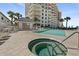 Beautiful pool area with a hot tub, lounge chairs, and tropical landscaping, offering a resort-style experience at 2403 S Atlantic Ave # 209, Daytona Beach Shores, FL 32118