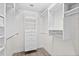 Bright walk-in closet features custom shelving, drawers, and hanging rods for optimal organization and storage at 2403 S Atlantic Ave # 209, Daytona Beach Shores, FL 32118