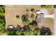Aerial view of the property displaying the home, long driveway, detached shed, and expansive backyard at 2485 Se 159Th Lane Rd, Summerfield, FL 34491