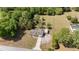 Aerial view of the property, displaying the home, long driveway, detached shed, and expansive backyard at 2485 Se 159Th Lane Rd, Summerfield, FL 34491