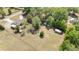 Aerial view of the property showcasing the home, outbuildings, and expansive land at 2485 Se 159Th Lane Rd, Summerfield, FL 34491