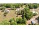 Aerial view of property showing home, enclosed pool, other homes and dense tree coverage at 2485 Se 159Th Lane Rd, Summerfield, FL 34491