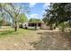 Spacious backyard featuring green grass, a shed and a screen porch at 2485 Se 159Th Lane Rd, Summerfield, FL 34491