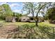 Fenced backyard featuring a lawn, a storage shed, and mature trees, offering a private outdoor space at 2485 Se 159Th Lane Rd, Summerfield, FL 34491