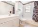 Bathroom featuring a single sink vanity, decorative wallpaper trim, and a shower/tub combo at 2485 Se 159Th Lane Rd, Summerfield, FL 34491
