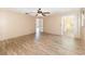 This bedroom features wood-look tile floors, ceiling fan, and sliding glass doors leading to a screened in porch at 2485 Se 159Th Lane Rd, Summerfield, FL 34491