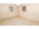 Bedroom with wood-look flooring, ceiling fan, neutral walls, and two windows for natural light at 2485 Se 159Th Lane Rd, Summerfield, FL 34491