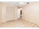Bedroom with wood-look flooring, ceiling fan, neutral walls, and closet with shutter doors at 2485 Se 159Th Lane Rd, Summerfield, FL 34491