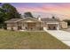 Charming single-story home featuring stone accents and a covered carport, nestled on a spacious lot with a well-manicured lawn at 2485 Se 159Th Lane Rd, Summerfield, FL 34491