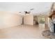 Open-concept living room with tile flooring, a stone fireplace, and seamless flow to the kitchen, ideal for modern living at 2485 Se 159Th Lane Rd, Summerfield, FL 34491
