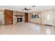 Bright living room with a stone fireplace, tile flooring, and ample natural light, creating a warm and inviting atmosphere at 2485 Se 159Th Lane Rd, Summerfield, FL 34491