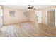 Spacious main bedroom with wood-look tile floors, a ceiling fan, and an en-suite bathroom, offering comfort and convenience at 2485 Se 159Th Lane Rd, Summerfield, FL 34491