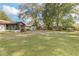 View of large backyard with trees and part of the home at 270 Sandyhook Ln, Deland, FL 32724