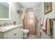 Well-lit bathroom with a tiled floor, vanity, sink, and shower behind a curtain at 270 Sandyhook Ln, Deland, FL 32724