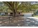 Charming single-story home with mature trees, a brick facade, and a two-car garage at 270 Sandyhook Ln, Deland, FL 32724