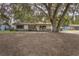 Classic single-story home with a brick facade and large shade tree in front yard at 270 Sandyhook Ln, Deland, FL 32724