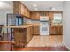 Well-lit kitchen featuring wooden cabinets and a breakfast bar at 270 Sandyhook Ln, Deland, FL 32724