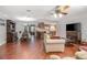 Spacious open-concept living room featuring wood-look floors and a ceiling fan at 270 Sandyhook Ln, Deland, FL 32724