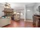 Cozy living room featuring a brick fireplace, tile floors, and a bright front door at 270 Sandyhook Ln, Deland, FL 32724