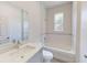 Bright bathroom with white subway tile, quartz vanity top, and a shower-tub combination with window at 28 Guava Ln, Ocklawaha, FL 32179