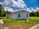 Exterior view of the home showing the lawn, white exterior, and clean window lines at 28 Guava Ln, Ocklawaha, FL 32179