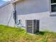 Exterior image of a modern AC unit and electrical panel at 28 Guava Ln, Ocklawaha, FL 32179