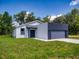 Charming single-story home featuring a two-car garage and manicured lawn at 28 Guava Ln, Ocklawaha, FL 32179