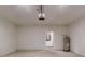 Garage features concrete floors, white walls, and a hot water heater at 28 Guava Ln, Ocklawaha, FL 32179
