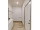 Functional laundry room with storage shelves and a utility sink for added convenience at 28 Guava Ln, Ocklawaha, FL 32179